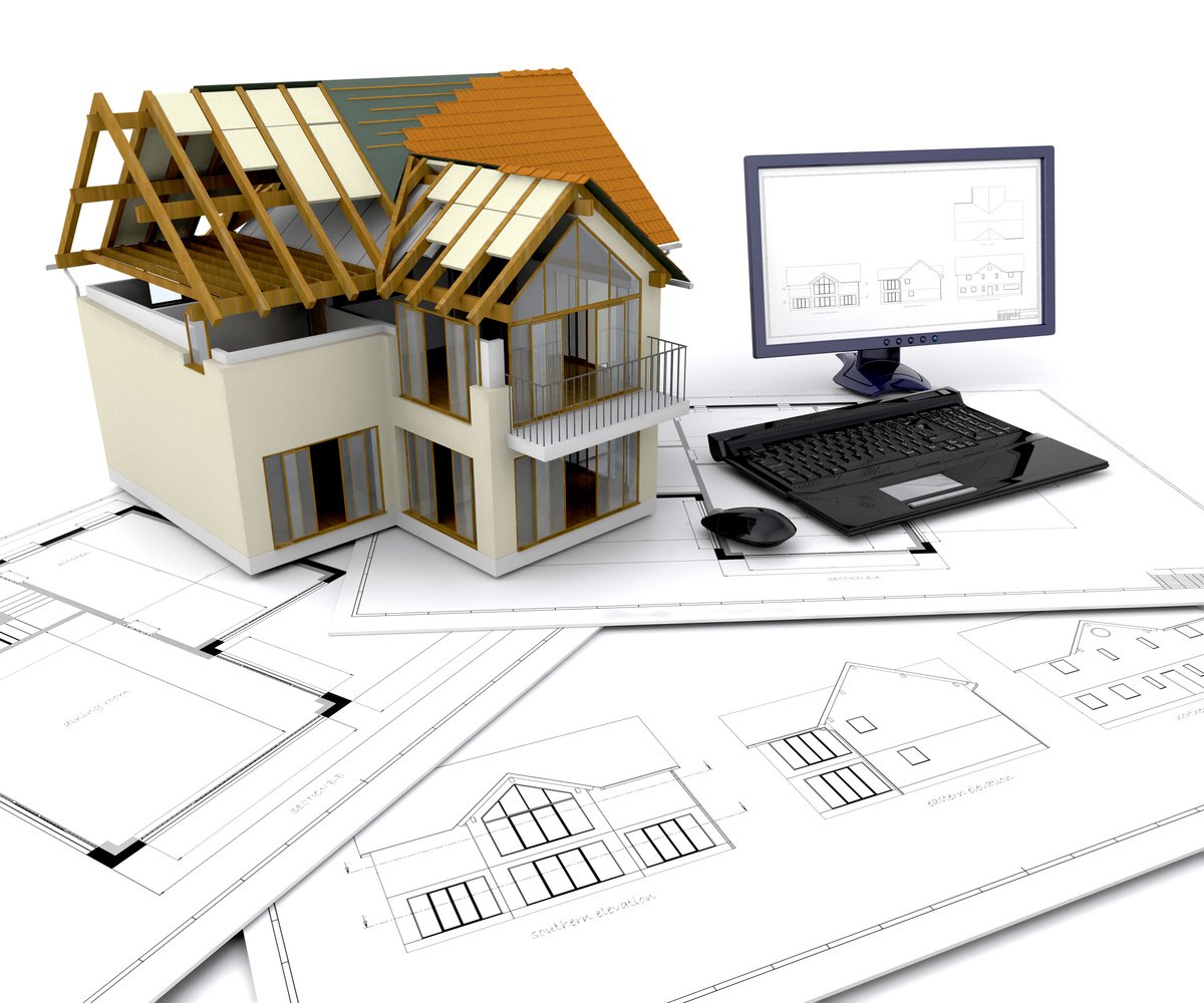 Architectural house model on blueprints — planning a construction project