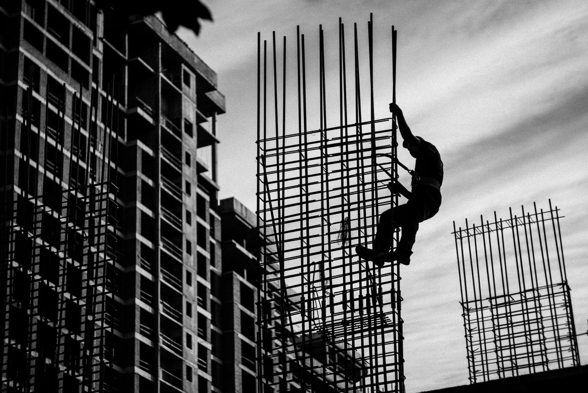 Worker climbing a rebar structure