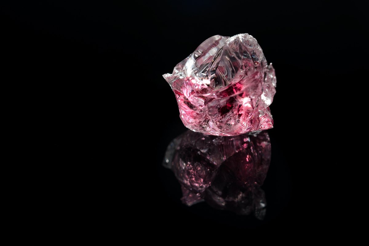 Raw uncut mineral crystal on black background